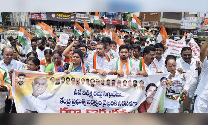 Congress leaders stage a protest at Mancherial IB Junction against the NEET paper leak and demand action against those responsible.