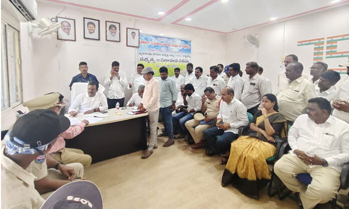 Devarakadra MLA G. Madhusudan Reddy reviewing municipal building plans and instructing officials on paddy procurement arrangements at Kottakota municipal headquarters.