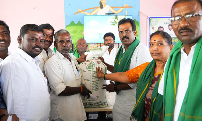 Devarakadra MLA GMR distributes green manure and Jeeluga seeds to farmers at subsidized rates during a Rythu Vedika program.