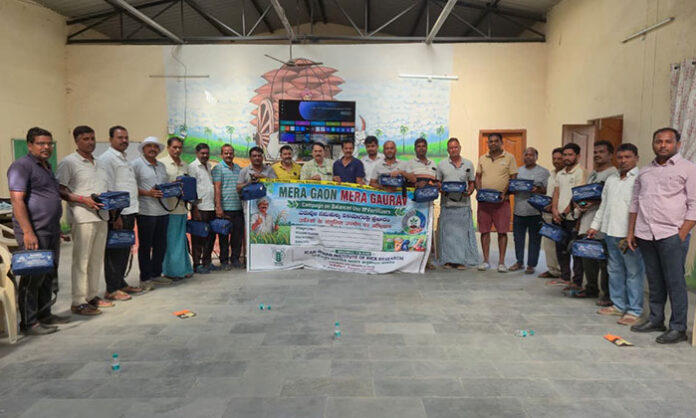 Farmers learning soil testing techniques at awareness program in Rayalapur village