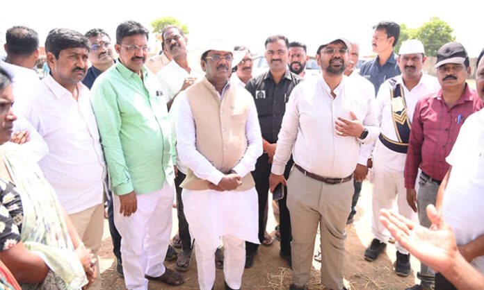 Minister Gaddam Vivekananda inspecting the paddy procurement process at Bavuraopet village purchase center in Chennur mandal along with district officials.