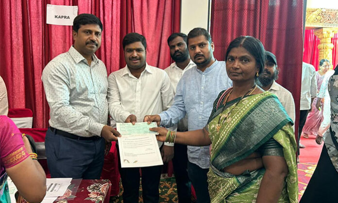 Officials distributing Kalyana Lakshmi and Shaadi Mubarak cheques to beneficiaries in Medchal district