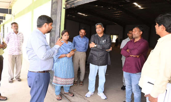 District Collector Kumar Deepak inspecting paddy storage warehouses and reviewing procurement operations in Mancherial district