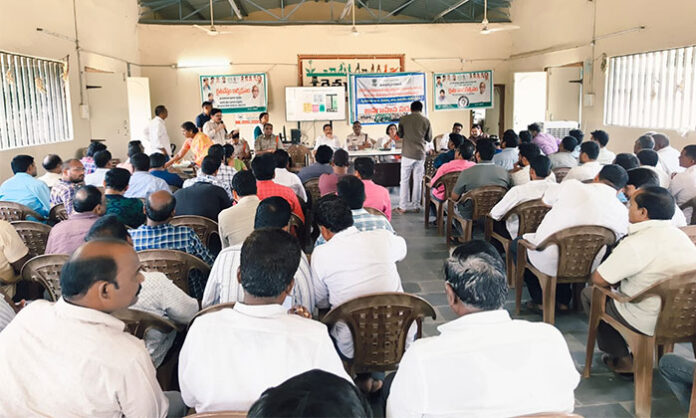 Mancherial ACP R. Prakash addresses seed and fertilizer dealers during an awareness program on legal action against fake seeds and agriculture violations.