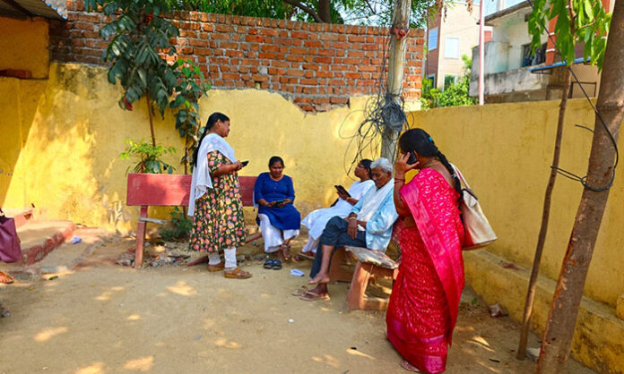 Patients and mothers with infants wait outside the Medchal Urban Primary Health Center after doctors failed to arrive on time.