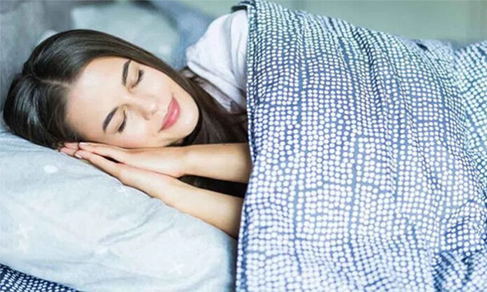 Person sleeping peacefully as sleep banking helps reduce the impact of future sleep deprivation