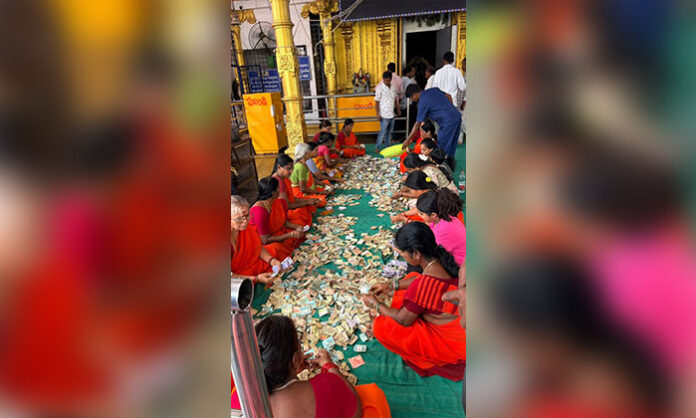Officials and devotees participate in the Hundi counting process at Sri Kurumurthy Temple in Ammapur village.