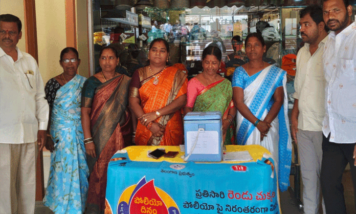 Sarpanch Mandugula Vijaya Srishailam Goud administers polio drops to children during the Pulse Polio immunization drive at Abdullapurmet Mandal headquarters.