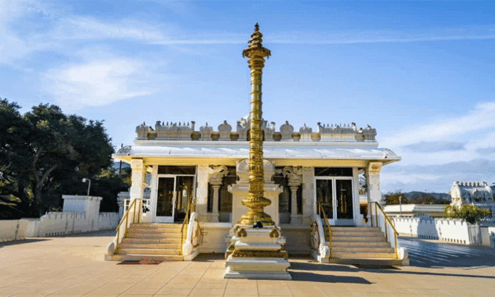 Dhwajasthambham stands in front of the sanctum of a Hindu temple, symbolizing the temple's spiritual identity and representing stability, devotion, and divine energy according to Hindu scriptures.