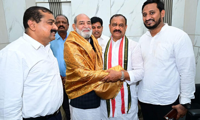 TPCC President Mahesh Kumar Goud honoring Dr. M.A. Ansari with a shawl during a meeting at Gandhi Bhavan on Telangana Formation Day.
