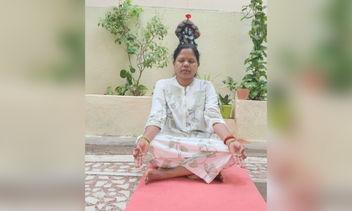 Former Councilor Hamsa Krishna Goud performs yoga asanas during International Yoga Day celebrations and promotes healthy living.