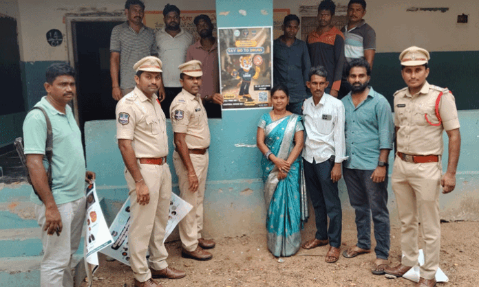 Venkatapuram CI Muthyam Ramesh addresses students during an awareness program on the International Day Against Drug Abuse at Alubaka village.
