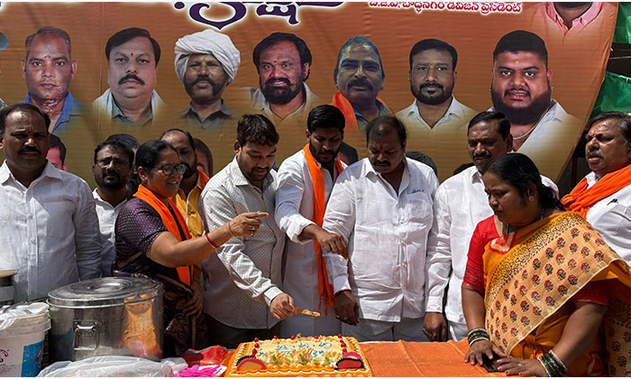 BJP leaders and supporters celebrate Union Minister Kishan Reddy's birthday at Warasiguda crossroads in Hyderabad by cutting a cake and distributing refreshments