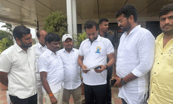 Kucharam Sarpanch Chitra Raghu submits a representation to MP Raghunandan Rao seeking funds for village development projects.