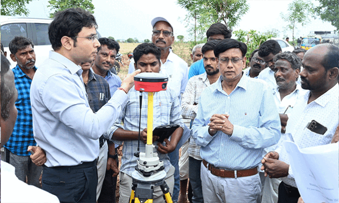 District Collector Bhavesh Mishra inspecting land survey and re-survey works in Lakshmanchanda Mandal and directing officials to complete the process accurately.