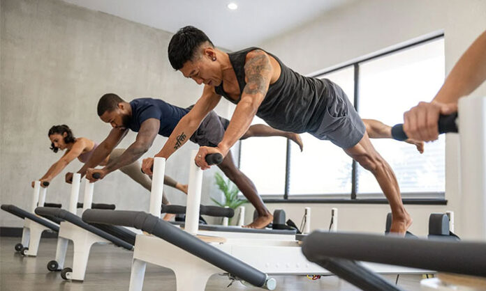 Mat Pilates exercises helping office workers improve posture, strengthen core muscles and reduce back and neck pain caused by prolonged computer use.