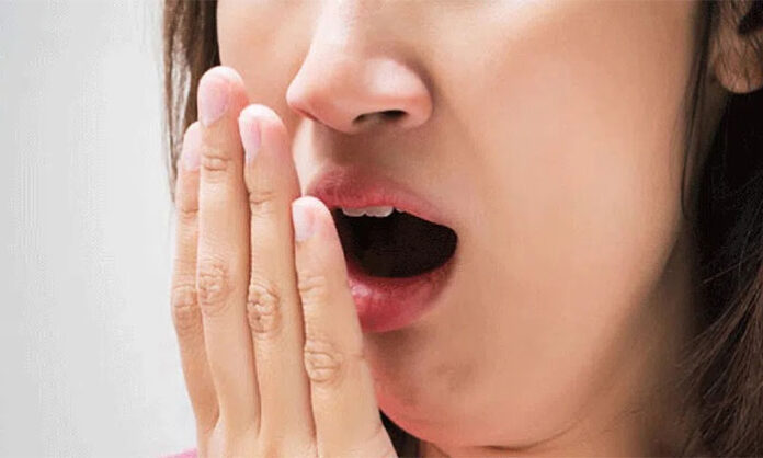Natural home remedies such as lemon, cardamom, and edible camphor suggested for treating bad breath and improving oral hygiene.