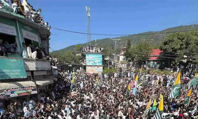 Mass protests and clashes in Pakistan-Occupied Kashmir with crowds demonstrating against Pakistan government and security forces responding with tear gas.