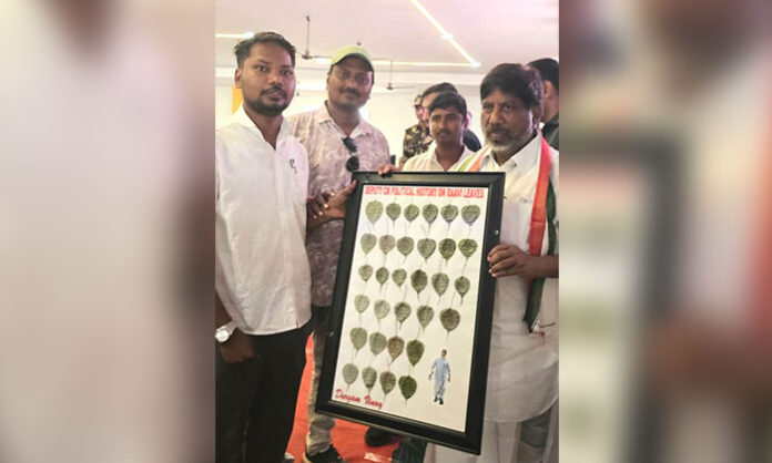 Young artist Vinay Kumar presenting Bhatti Vikramarka's political history inscribed on Peepal leaves as a unique birthday tribute.