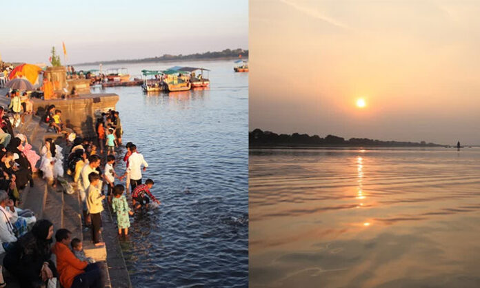 Devotees performing holy bath rituals during Yamuna River Pushkarams along river ghats in India.