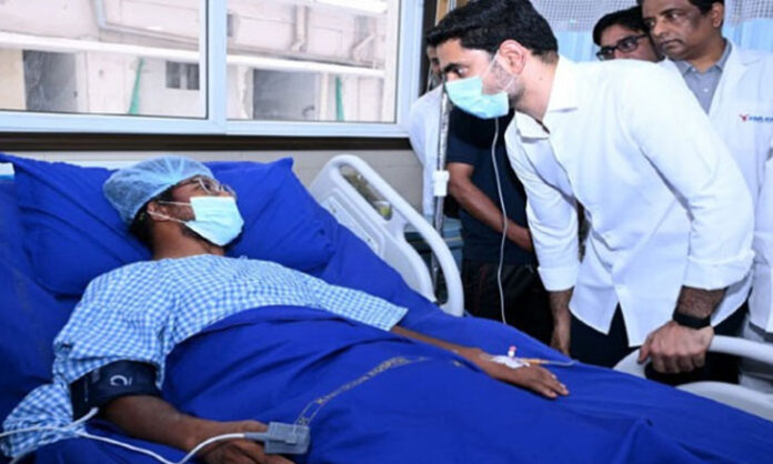 Minister Nara Lokesh meeting steel plant fire accident victims undergoing treatment at KIMS Hospital in Visakhapatnam.