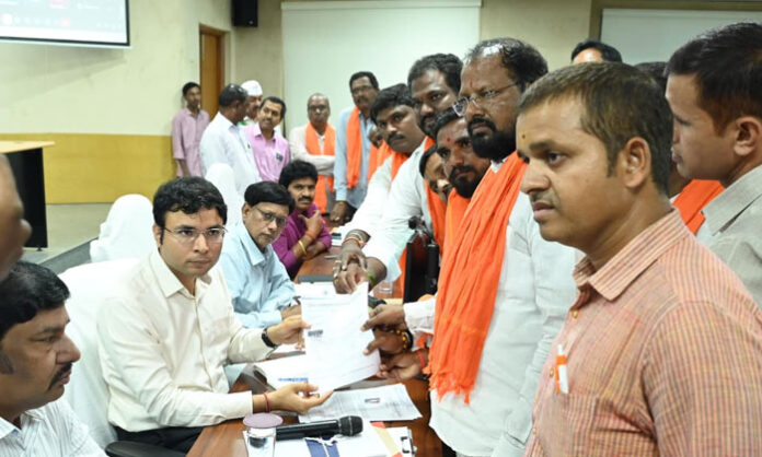 District Collector Bhavesh Mishra receives public grievances during the Praja Vani program and directs officials to resolve applications without delay.