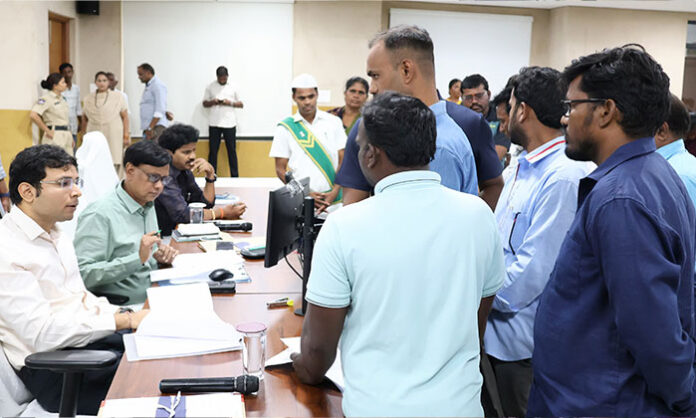 Nirmal District Collector Bhavesh Mishra receives public grievances during the Prajavani program and directs officials to resolve applications promptly.