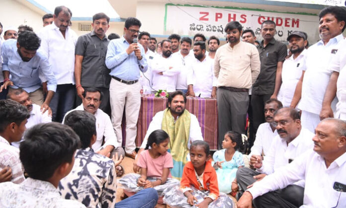 Peddapalli MP Gaddam Vamsi Krishna distributes school bags to government school students during a student welfare program.