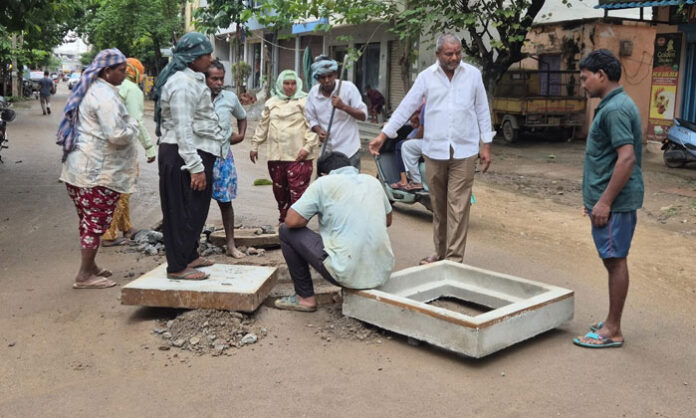 GHMC officials carrying out road and drainage repair works in Housing Board Colony following public complaints.
