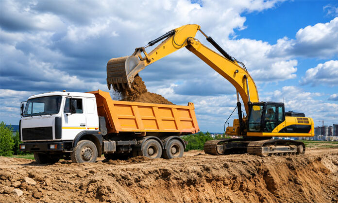 Heavy machinery allegedly carrying out illegal sand mining operations in the Manair River at the Utur sand reach in Manakondur Mandal.