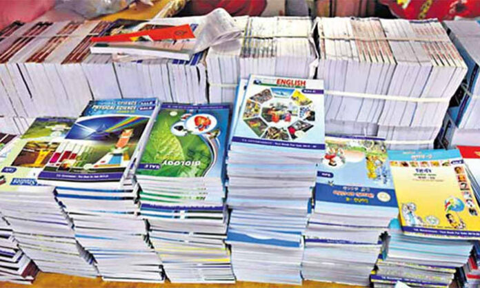 Students at a government junior college waiting for Telugu medium and vocational Intermediate textbooks after the academic year began.