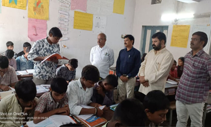 Kamareddy DEO Mallikarjun interacts with students during a surprise inspection at Krishnajivadi High School in Tadwai Mandal.