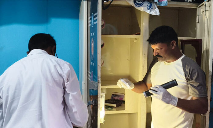 Police officials inspecting one of the houses targeted during a burglary spree in Venkatapur Colony, Nirmal.