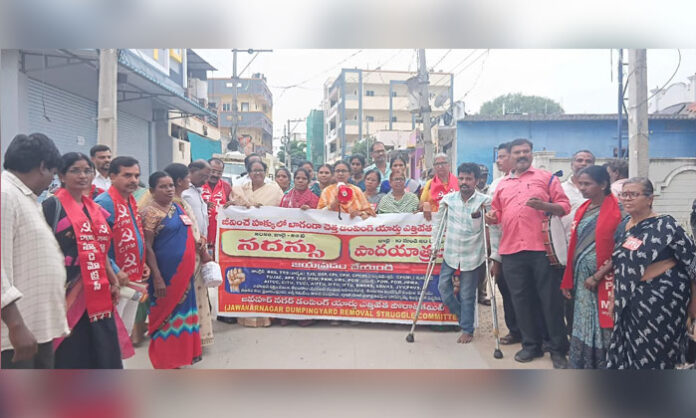 Vimalakka demands the removal of the Ramky dumping yard at Jawahar Nagar during a public awareness padayatra.