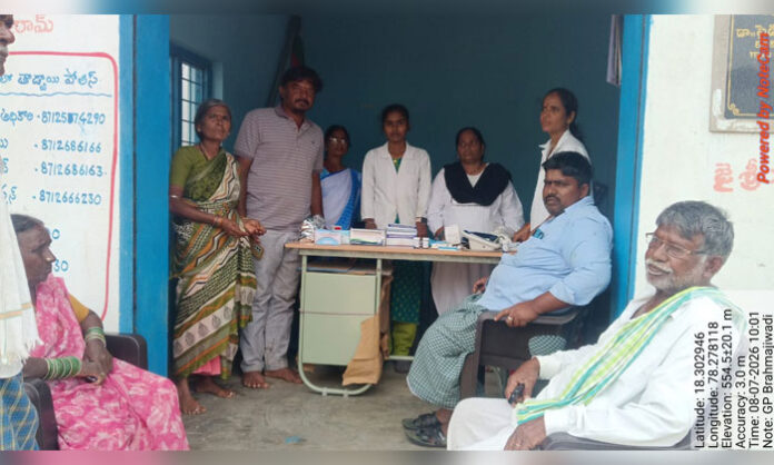 Medical staff conducting free blood sugar and blood pressure tests at the free health camp in Brahmajiwadi village.