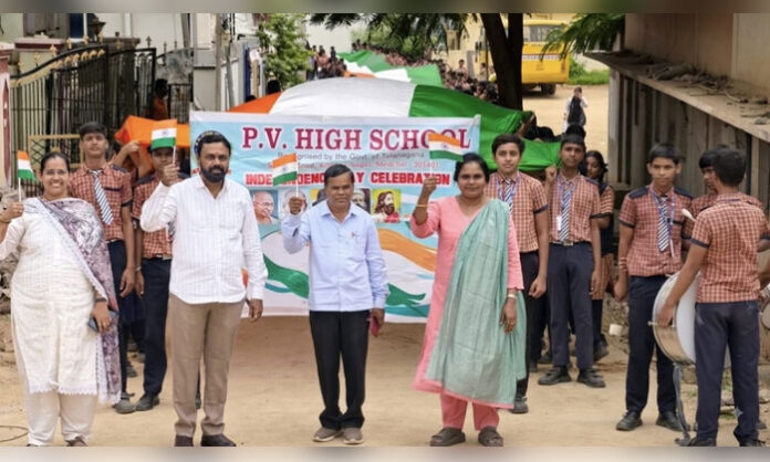 PV School students carry a 300-foot national flag during an Independence Day rally in Medchal