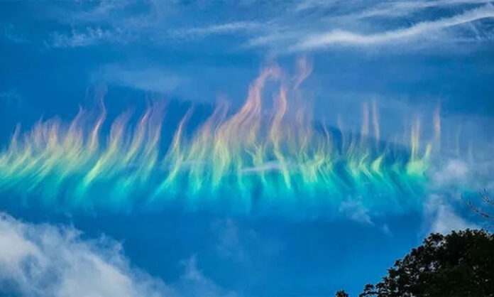 A rare circumhorizontal arc, commonly known as a fire rainbow, illuminates the sky over West Virginia with vivid bands of color.