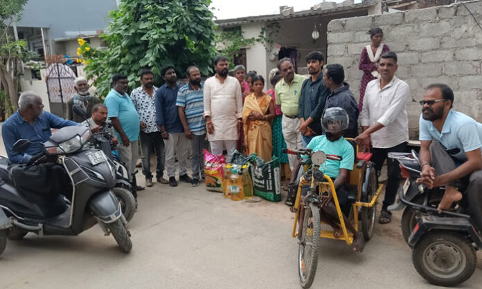 Leaders and disability rights representatives provide cooking supplies to Sammaiah's family in Jawaharnagar
