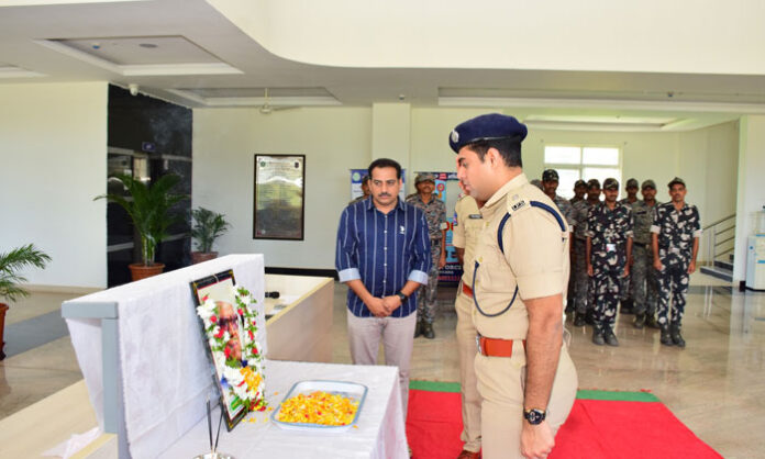 Additional SP Chetan Nitin pays floral tributes to Acharya Konda Laxman Bapuji's portrait during his birth anniversary celebrations at the Jagtial District Police Office.