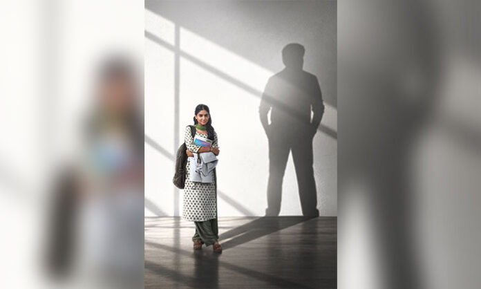 Anaswara Rajan as Ammulu Paapa in Kaaka first look poster with Chiranjeevi’s shadow