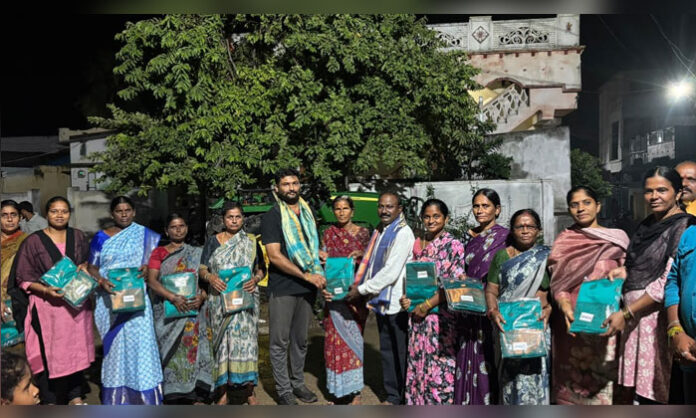 Nava Chaitanya Youth members distribute sarees to women during Vinayaka Chavithi celebrations in Pedaveedu village, Mattampally Mandal.