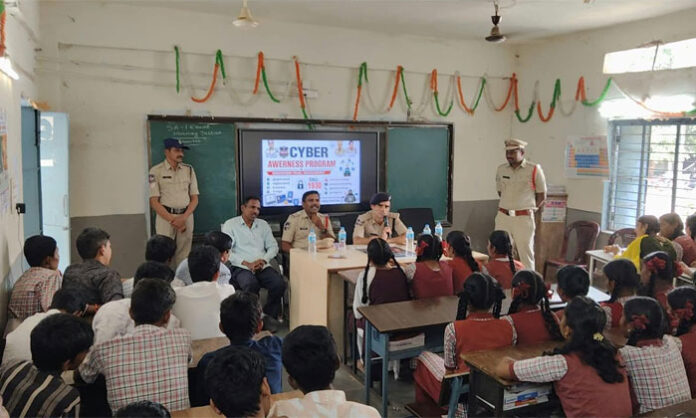Eturunagaram ASP Manan Bhat addresses students during a cybercrime awareness program at Zilla Parishad High School in Venkatapuram.