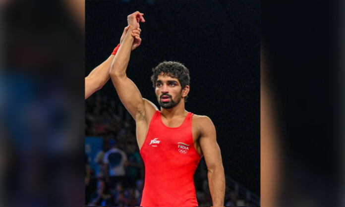 Aman Sehrawat celebrates after winning the men's 57kg freestyle wrestling gold medal at the 2026 Asian Games