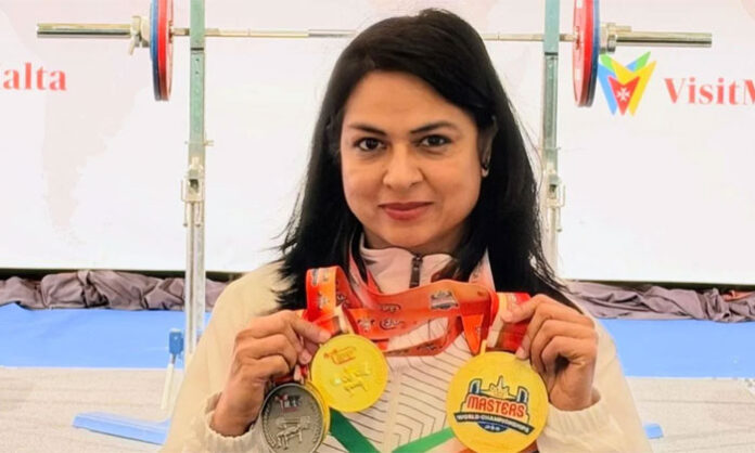 IRS officer Ekta Bishnoi celebrates her three gold medals at the World Masters Classic Powerlifting Championships in the USA.