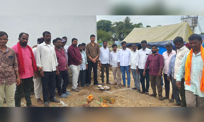 MPDO Praveen and village representatives perform the ground-breaking ritual for Indiramma houses in Gangireddula Gudem, Somakkapeta.