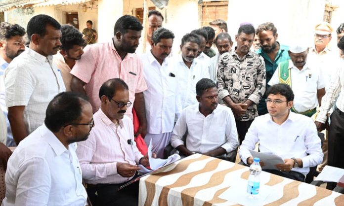 Collector Bhavesh Mishra reviews Indiramma housing applications for eligible poor families in Dimmadurthi village.