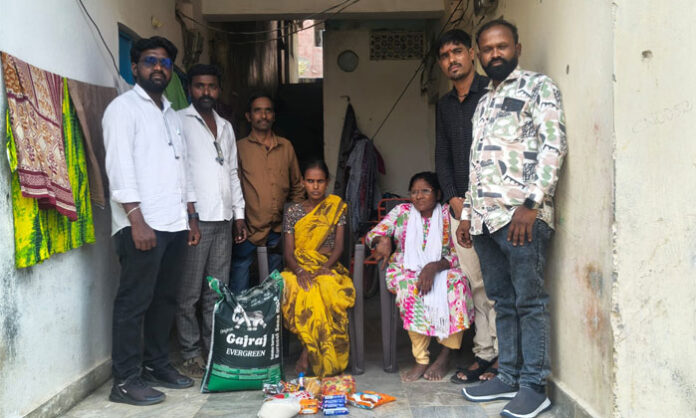 Jawaharnagar community leaders distribute essential commodities to a family in the Differently-Abled Colony