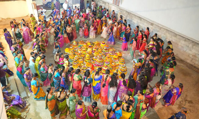 Women and young girls celebrate Saddula Bathukamma with colorful floral arrangements, traditional songs and dances in Kadthal.