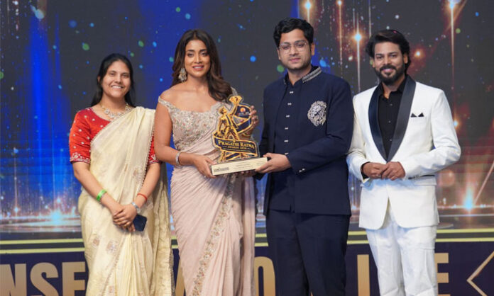 Nikhil Gunda receives the AI Educator and Innovator of the Year 2026 award from actress Shriya Saran at the Pragati Ratna Awards in Hyderabad.