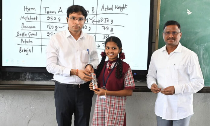 Nirmal Collector Bhavesh Mishra interacts with tenth-grade students during an inspection of Kasturba Gandhi Balika Vidyalaya in Kallur village.